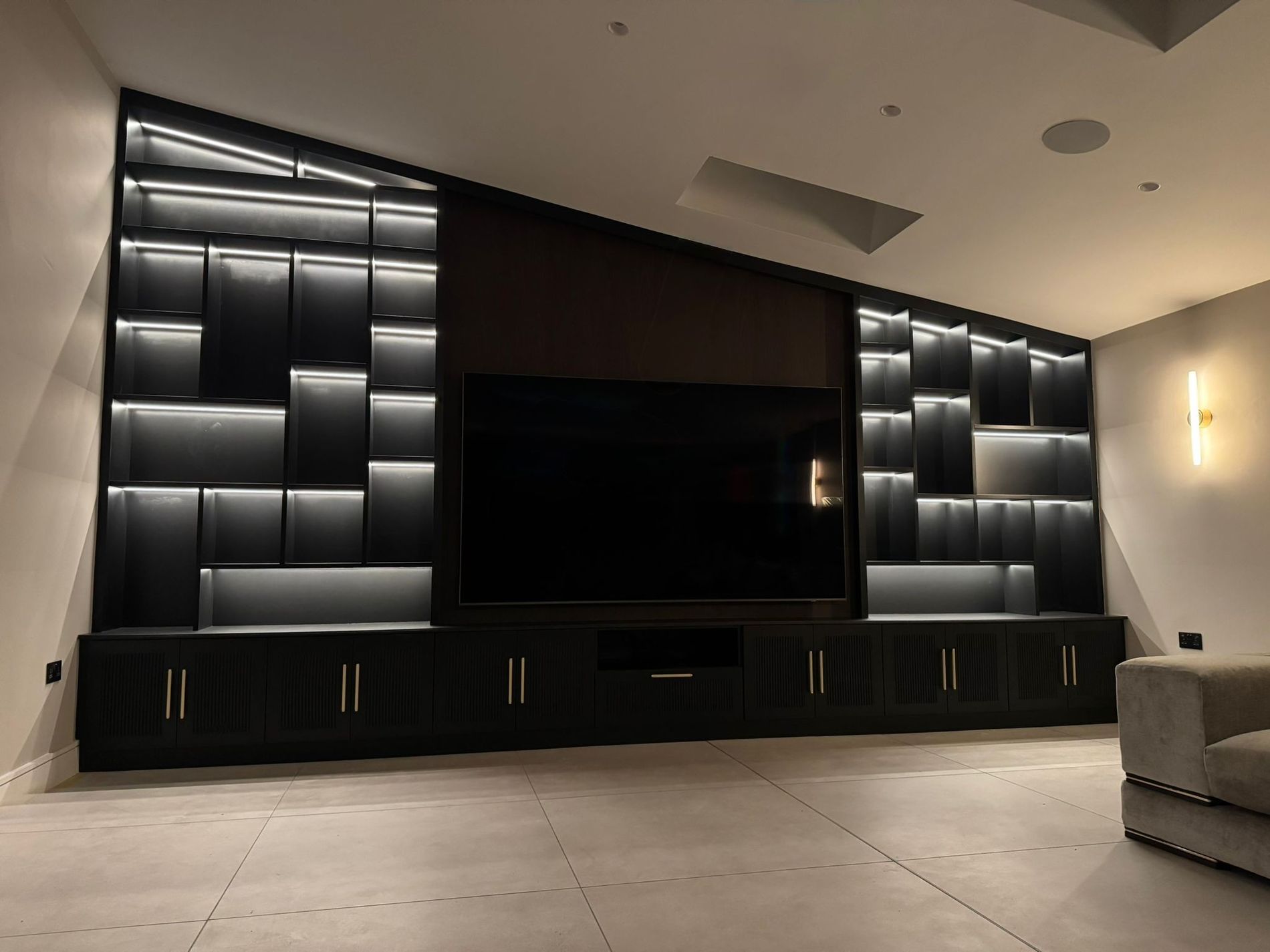 Media wall lit by programmed LED lighting