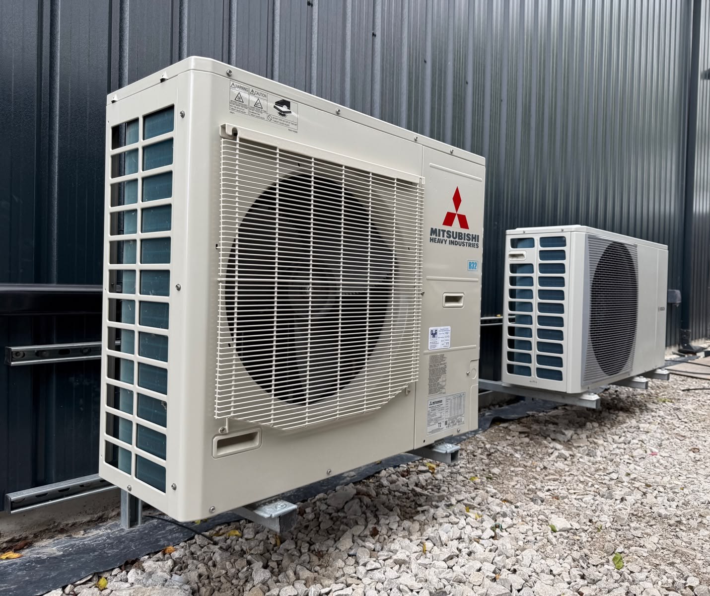 Twin air source heat pumps outside the building