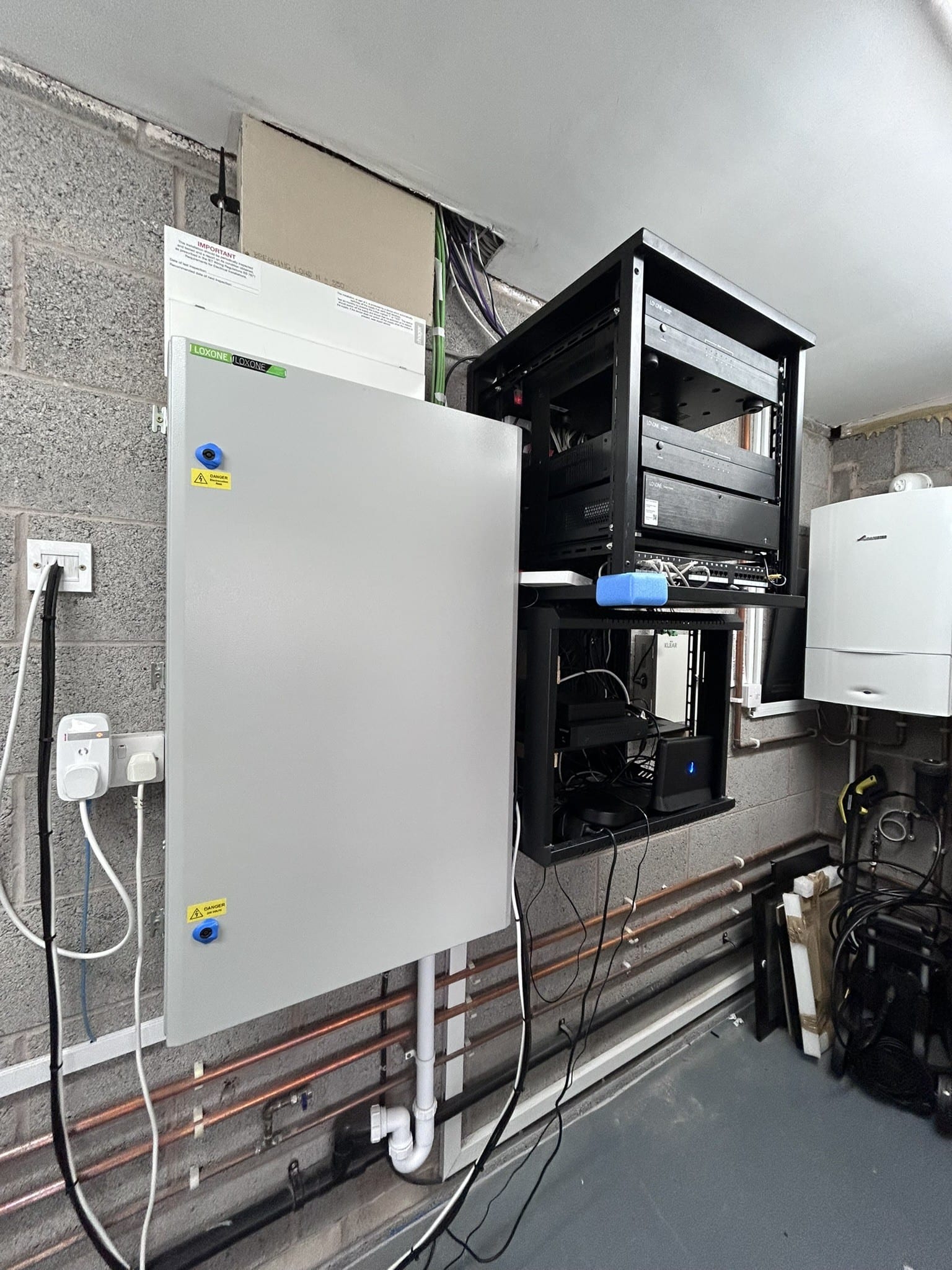 A tangled, mislabelled Loxone control cabinet left behind by a previous installer